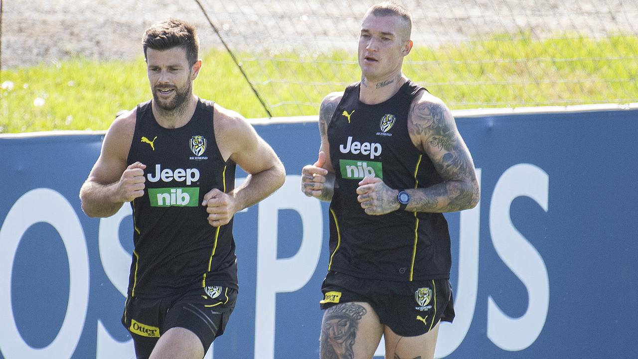 Trent Cotchin and Dustin Martin run laps at training.