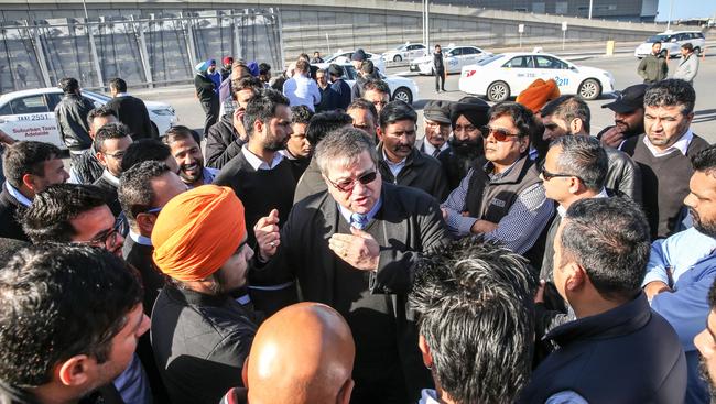 Taxi drivers protest at Adelaide airport in response to the decision allowing Uber to pick up travellers. Picture: AAP/Russell Millard