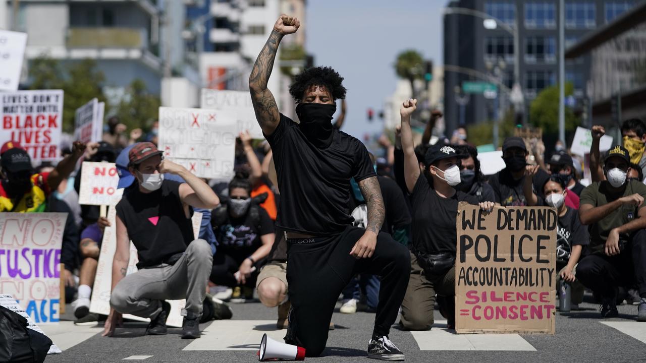 Demonstrators kneel in a moment of silence outside the Long Beach Police Department on Sunday, May 31, 2020. Picture: Ashley Landis/AP