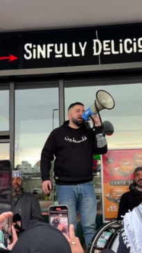 Hash Tayeh addresses protesters outside Coburg North restaurant