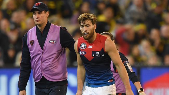 Captain Jack Viney is helped from the field after being injured last season.