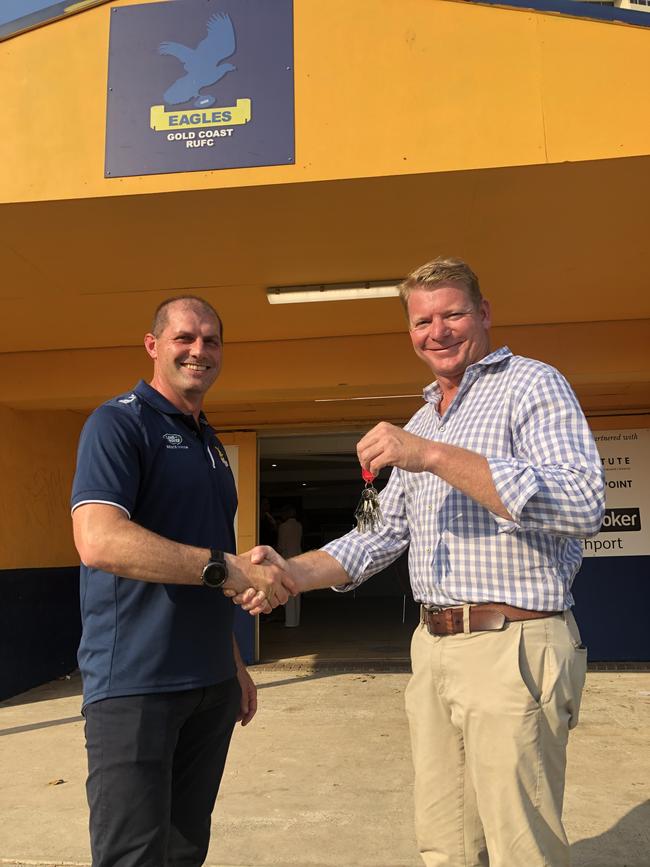 Outgoing Gold Coast Eagles president Ben Latimer hands keys to the club to incoming president Jason Teren. Picture: Supplied