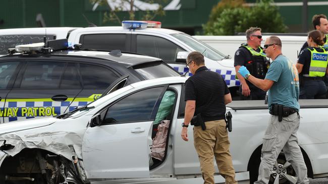 Police examine a ute after a pursuit that ended on the Surfcoast Highway at Armstrong Creek. Picture: Alison Wynd]