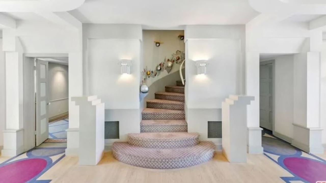 However, some of Simmons' unique design choices remain, including a mural of cherubs on the wall of one staircase. Picture: Realtor