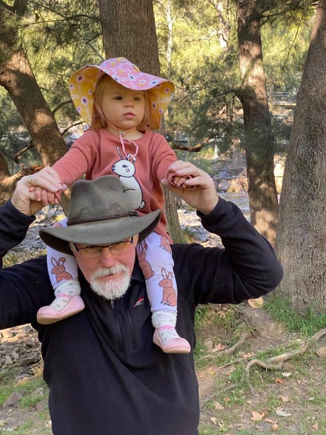 Nigel Harris with his granddaughter Evelyn. The 60-year-old was tragically killed when a vehicle veered off the road and into spectators at the Finke Desert Race on Monday. Picture: Facebook