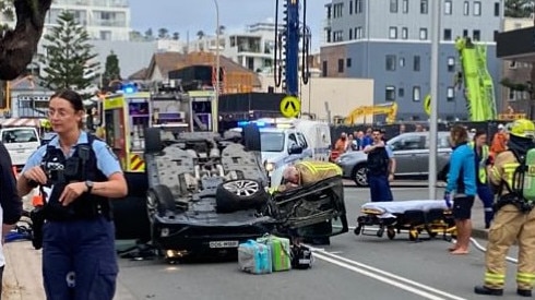 A driver has been taken to hospital after his car hit a construction vehicle and flipped near Manly Beach. Picture: manlyobserver.com.au
