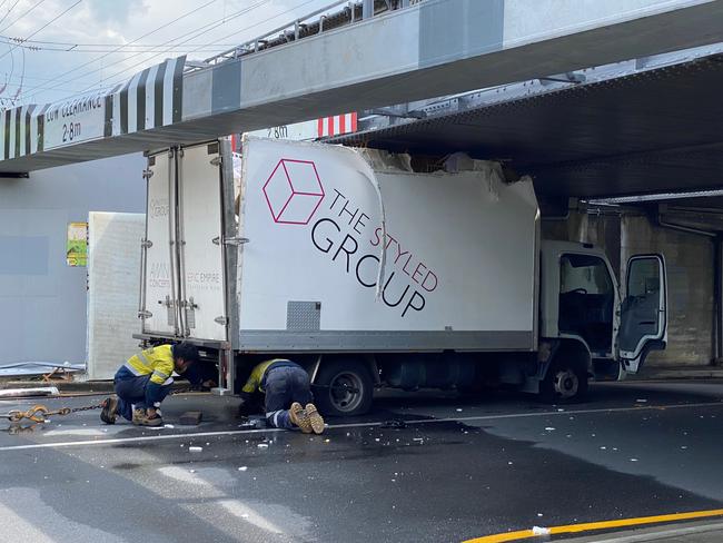 The truck hit a rail bridge near Indooroopilly station.