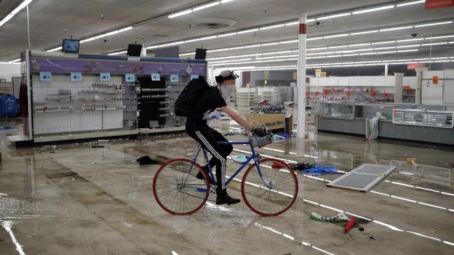 A biker cruises through an emptied Kmart in Minneapolis. Picture: AP