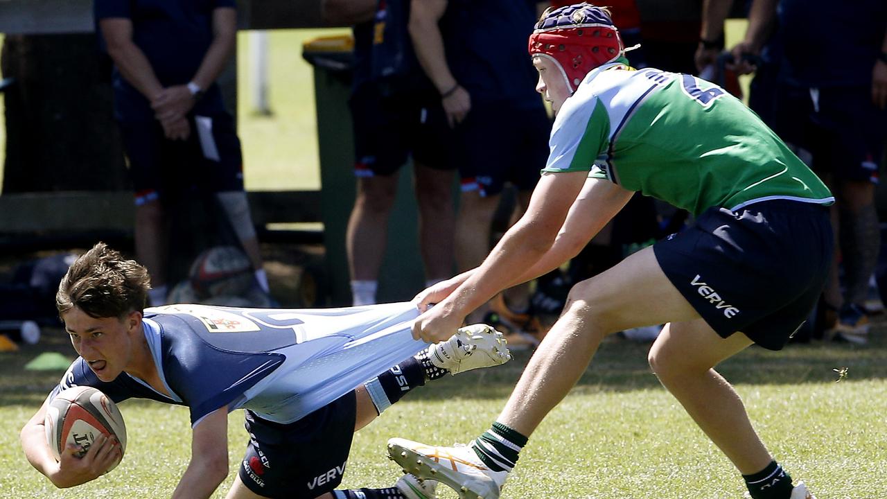 Wilson Ruthven from U14 Gen Blue being tackled by Edward Bryant from the U15 Ella team at last year’s Gen Blue Cup for Under 15s and U14s. Picture: John Appleyard