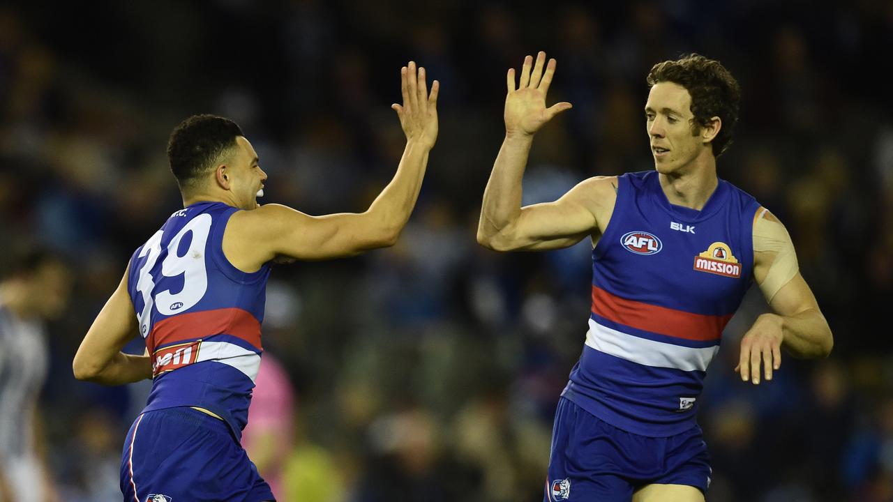 Western Bulldogs players Jason Johannisen (left) and Robert Murphy react after Johannisen kicked a goal against the North Melbourne Kangaroos in round 22 of the AFL at Etihad Stadium, Saturday, Aug 29, 2015. (AAP Image/Julian Smith) NO ARCHIVING, EDITORIAL USE ONLY