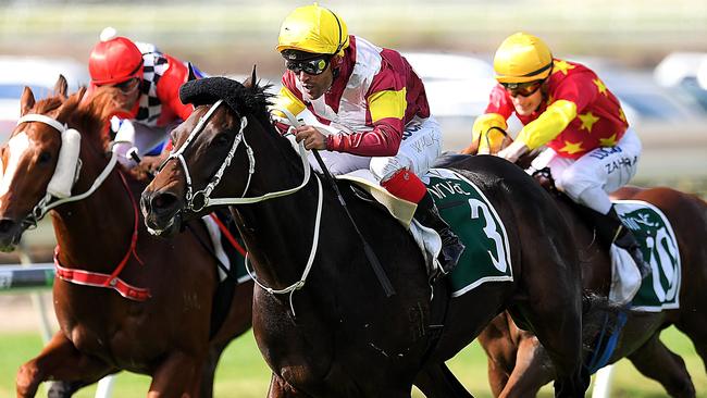 Jockey Michael Walker rides Sambro (centre) to victory in race 3, the Ascot Green Queensland Guineas, during UBET Stradbroke Day at Doomben Racecourse in Brisbane, Saturday, June 9, 2018. (AAP Image/Albert Perez) NO ARCHIVING, EDITORIAL USE ONLY