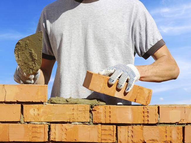 bricklayer laying bricks to make a wall for pink floyd economics paul syvret brexit