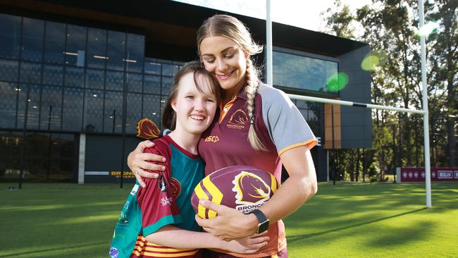 Maisie Andrews, 13, with NRLW Brisbane Broncos player Kody House. Picture: AAP