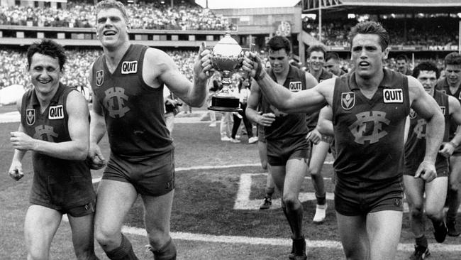 Leon Harris, John Ironmonger and Michael Conlan celebrate Fitzroy’s 1989 reserves premiership.