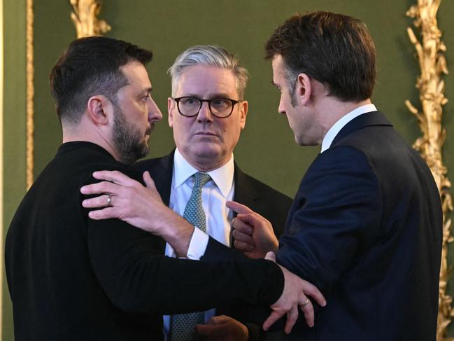 (L-R) Ukraine's President Volodymyr Zelensky, Britain's Prime Minister Keir Starmer and France's President Emmanuel Macron embrace after a meeting in central London. Picture: AFP