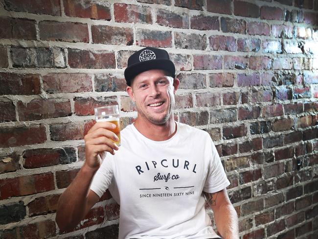 Mick Fanning celebrates with a beer at his Balter brewery at Currumbin after being awarded an AO in the Australia Day honour’s list. Picture: NIGEL HALLETT
