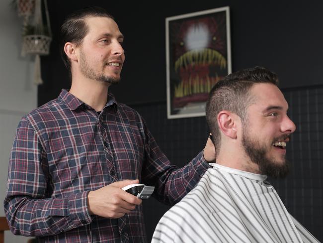 Jay Braslin, the owner of Bob’s Your Uncle, shares a joke with customer Ash Johnson. Picture: LUKE BOWDEN