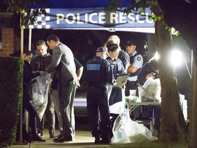 Police sift through evidence seized during a raid on a property in Sproule St, Lakemba. Other properties in Surry Hills, Wiley Park and Bankstown were also raided. Picture: Damian Shaw