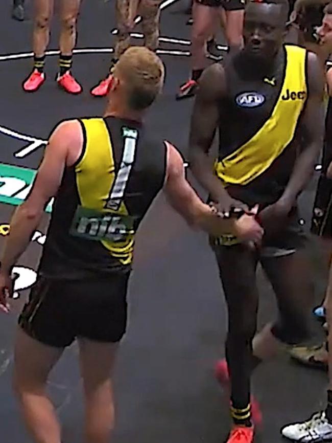 Richmond player Nick Vlastuin is seen groping Mabior Chol during the team song in the rooms.