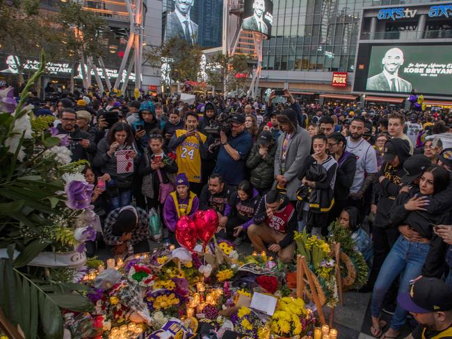 People gather around a makeshift memorial for Bryant in LA. Picture: AFP