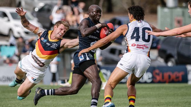 Emmanuel Irra runs into trouble against the Crows. Picture: Morgan Sette/AAP