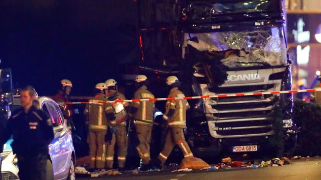 Police and emergency workers stand next to a crashed truck at the site of an accident at a Christmas market on Breitscheidplatz square. Picture: Fabrizio Bensch/Reuters/Picture Media