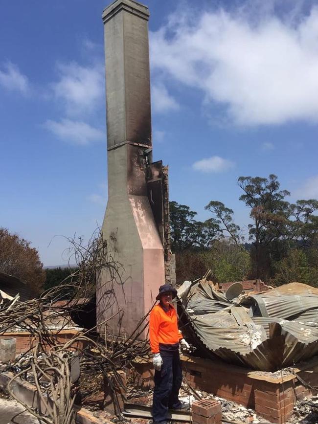 A resident of Bundanoon in NSW with the remains of a home after the 2019-20 fires.