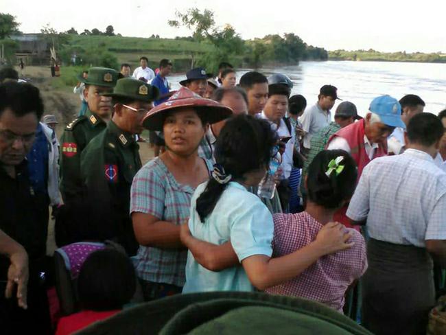 Relatives watch as rescue personnel prepare to search for victims of the ferry disaster. Picture: AFP