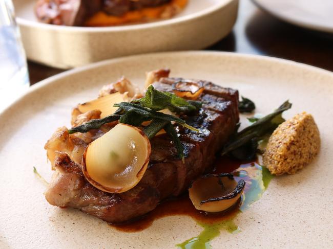 Evenfall’s King Island porterhouse with onion petals, parsley oil, seeded mustard, crispy sage leaves, and jus. Picture: Stephanie Dalton