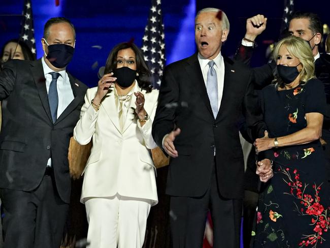 Joe Biden, second right, reacts to a confetti drop with wife Jill Biden, from right, Vice President-elect Kamala Harris and her husband Douglas Emhoff. Picture: Getty Images