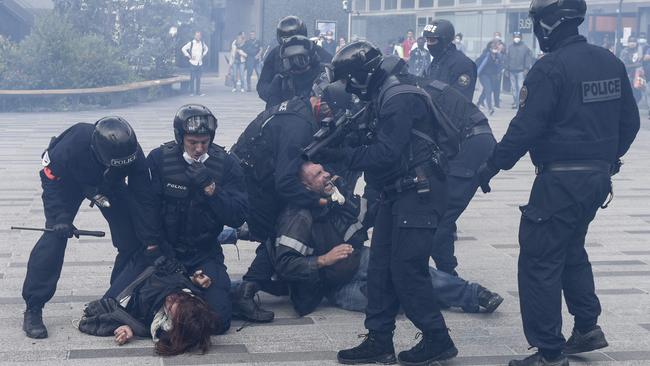 French police detain a pair of protesters in the western city of Nantes on Saturday. Picture: AFP