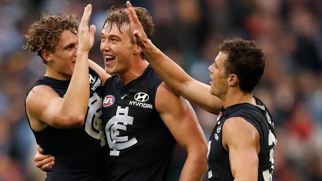 MELBOURNE, AUSTRALIA - MAY 12: Charlie Curnow of the Blues (left) celebrates on the final siren with Patrick Cripps of the Blues (middle) and brother Ed Curnow of the Blues (right) during the 2018 AFL round eight match between the Carlton Blues and the Essendon Bombers at the Melbourne Cricket Ground on May 12, 2018 in Melbourne, Australia. (Photo by Adam Trafford/AFL Media/Getty Images)