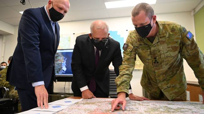 Mr Morrison and Defence Minister Peter Dutton given a run down of the floods at the Gallipoli Barracks on Monday. Picture: NCA NewsWire / Dan Peled