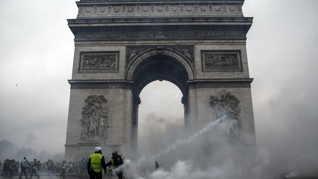 Demonstrators clash with riot police at the Arc de Triomphe during a protest of Yellow vests (Gilets jaunes) in Paris. Picture: Abdulmonam Eassa/AFP