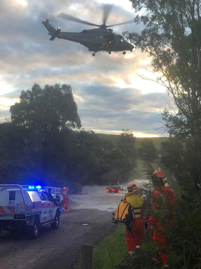 A driver is winched to safety after his vehicle became stuck in floodwaters near Mount Cottrell. Picture: Victoria SES