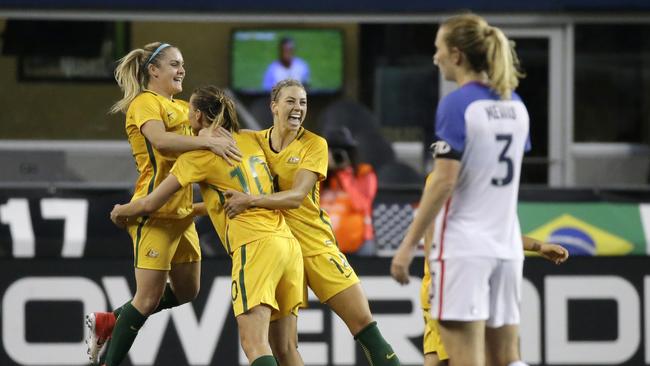 Australia's Ellie Carpenter, Emily van Egmond and Alanna Kennedy, from left, celebrate.