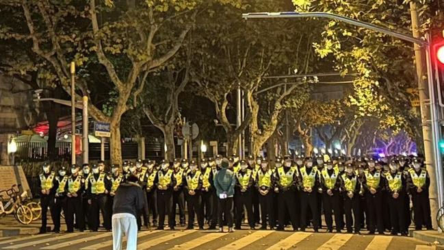 Police confront a crowd in Shanghai calling for Xi Jinping to stand down. Picture: Getty Images.