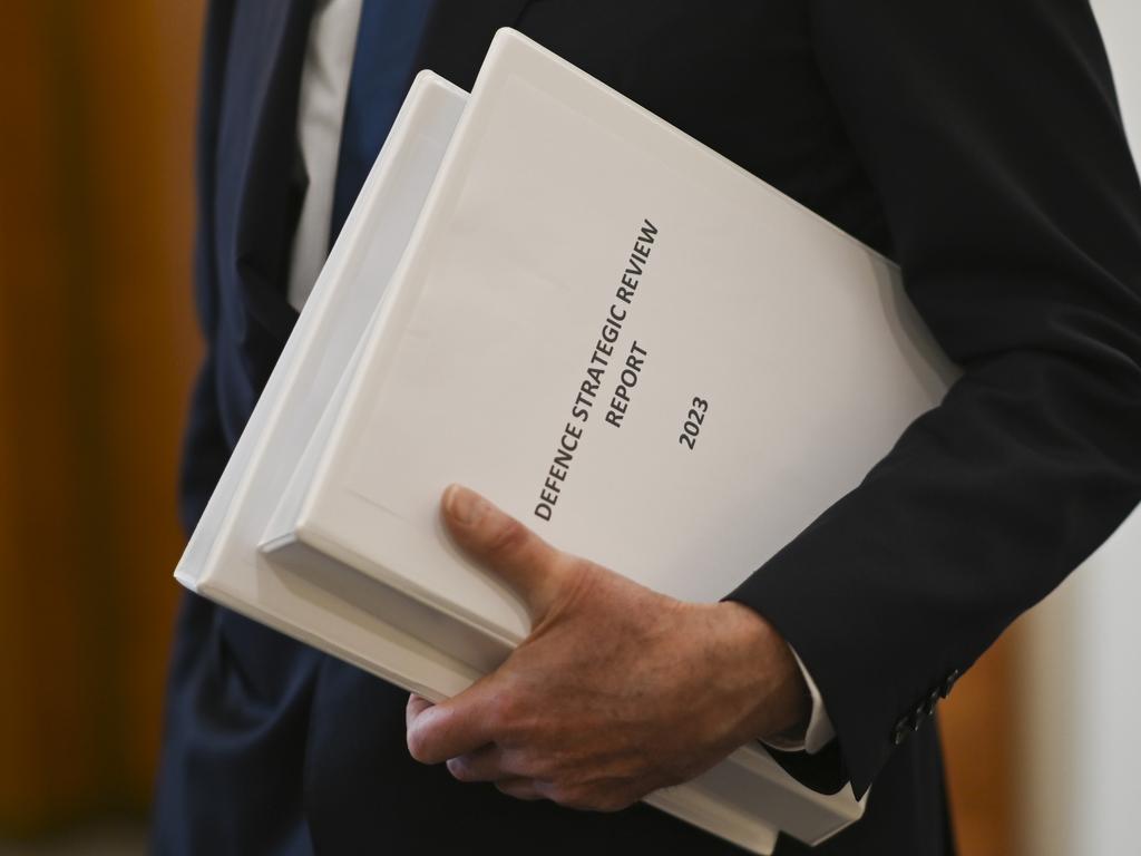 Sir Angus Houston delivers the Defence Strategic Review 2023 to Prime Minister Anthony Albanese and Deputy PM and Minister of Defence Richard Marles at Parliament House on Tuesday. Picture: Getty Images