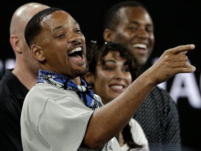 U.S. actor Will Smith reacts after watching the third round match between France's Jo-Wilfried Tsonga and Australia's Nick Kyrgios at the Australian Open tennis championships in Melbourne, Australia, Friday, Jan. 19, 2018. (AP Photo/Dita Alangkara)