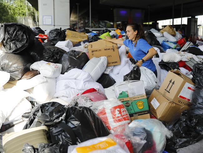 A volunteer helps sort clothes donated to victims of the blaze that gutted Grenfell Tower. Picture: AFP/Tolga Akmen