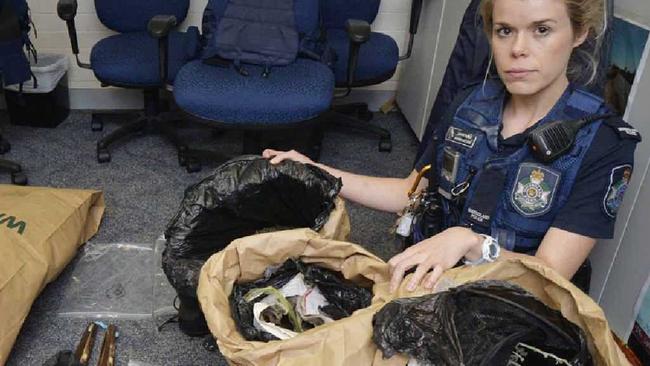 DRUG RAID: Constable Jasmin McCabe with marijuana allegedly found at a Goodna address.