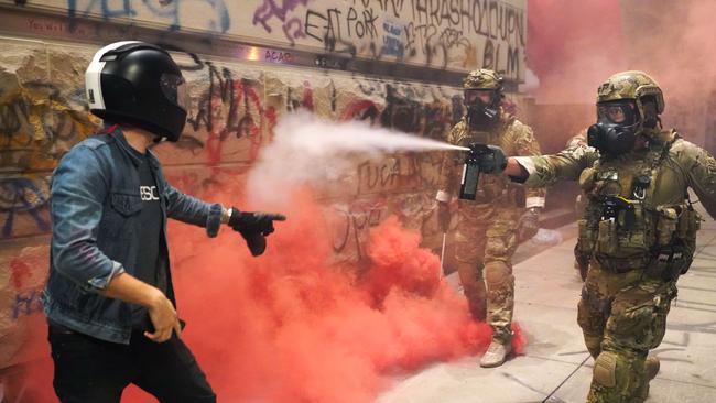 A federal officer pepper sprays a protester in front of the Mark O. Hatfield US Courthouse. Picture: AFP