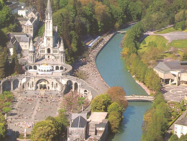 Undated. An aerial of the town of Lourdes showing its fortified castle and the Gave River. travel tourism France