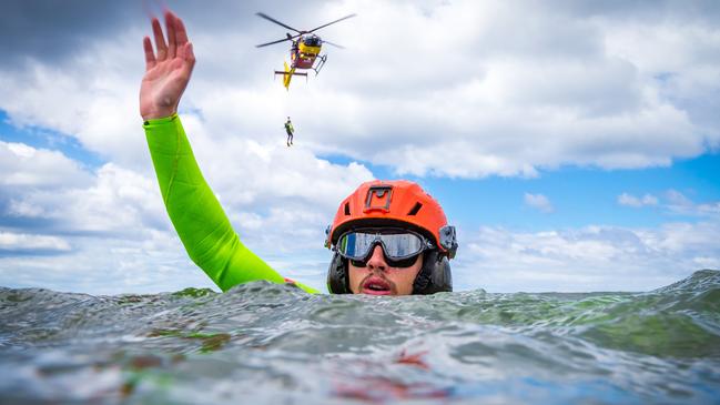 Alex Schwarcz raises his hand as Liam O'Callaghan approaches on the winch. Picture: Jake Nowakowski