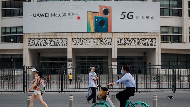 A new billboard commercial for Chinese telecom brand Huawei shows off the company’s new 5G smartphones on a street in Beijing on Friday. Picture: AFP