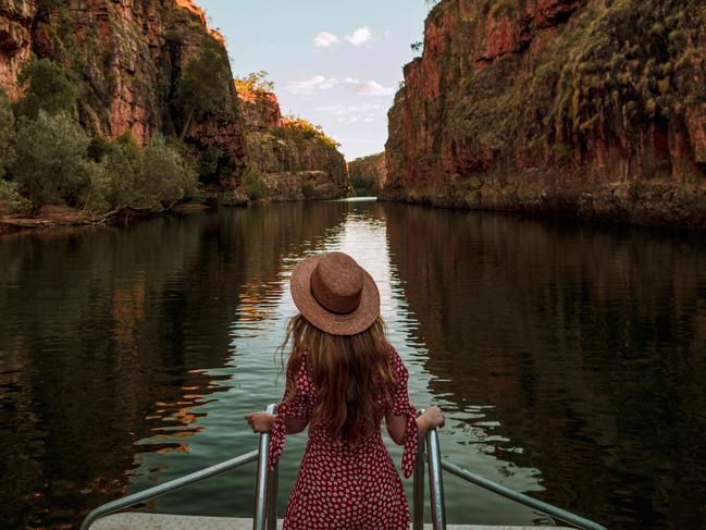 A visitor stands at the front of a cruise boat as it travels along Katherine Gorge. Nitmiluk National Park covers a vast area of escarpment country, including 13 gorges along the Katherine River carved from the ancient sandstone country.Picture: Emilie Ristevski / Tourism NT