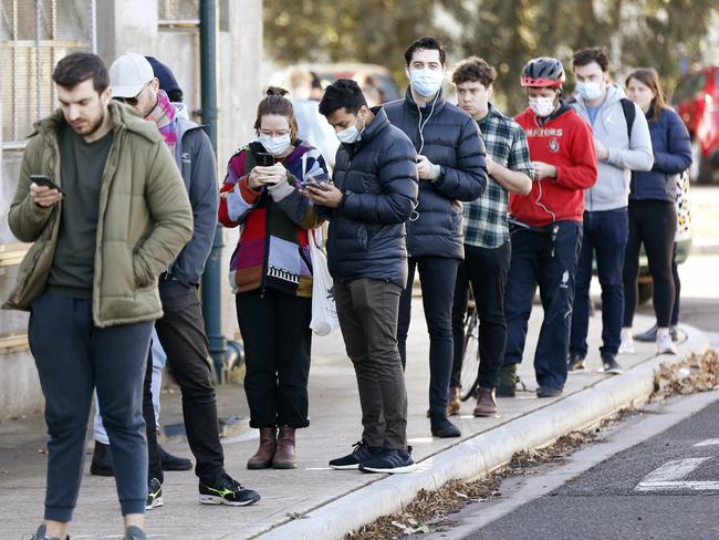 MELBOURNE, AUSTRALIA - JULY 02: Members of the public line up outside a walk in COVID testing clinic in Brunswick on July 02, 2020 in Melbourne, Australia. The clinic was set up by the Royal Melbourne Hospital on short notice in the football club rooms at A.G. Gillen Oval. Lockdowns across Melbourne have come into effect for residents of suburbs identified as COVID-19 hotspots following a spike in new coronavirus cases through community transmission. From midnight Wednesday 1 July, residents of 10 postcodes will only be able to leave home have for exercise or work, to buy essential items including food or to access childcare and healthcare. Businesses and facilities in these lockdown areas will also be restricted and cafes and restaurants can only open for take-away and delivery. The restrictions will remain in place until at least 29 July. (Photo by Darrian Traynor/Getty Images)