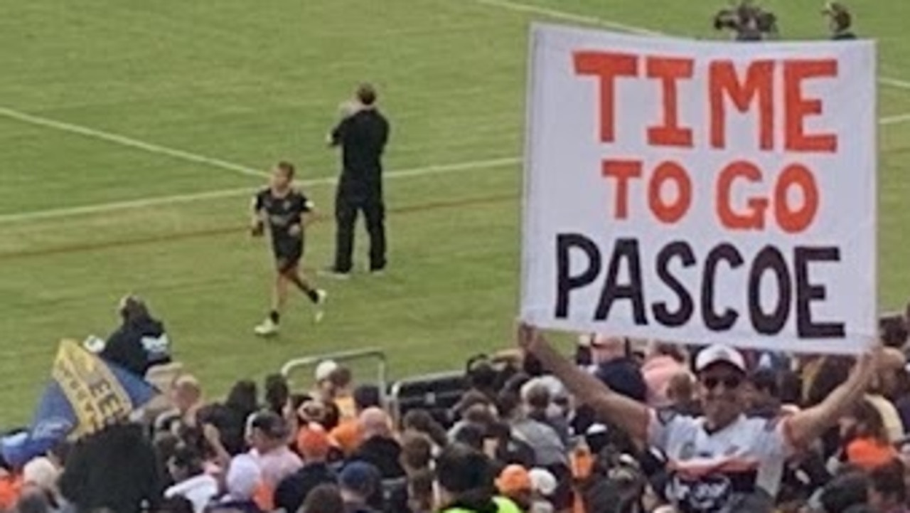 Wests Tigers fans protested in the 12th minute by standing up, with one fan telling CEO Justin Pascoe it's time to go.