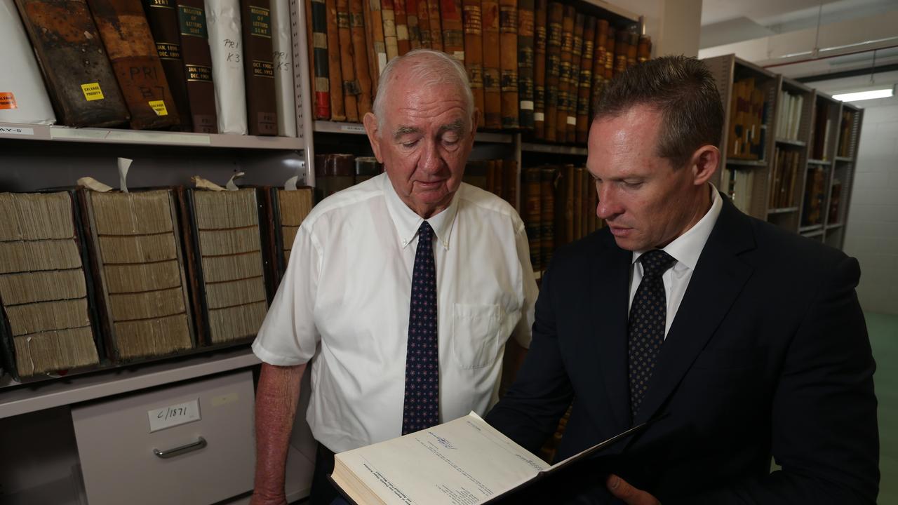 Former Qld Premier Mike Ahern and Minister Mick de Brenni with the original Fitzgerald Report at Qld State Archives. December 20th, 2018. (AAP Image/Richard Waugh).