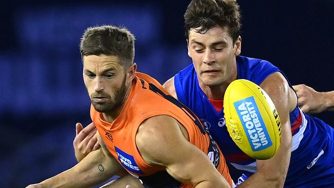 MELBOURNE, AUSTRALIA - JUNE 19: Callan Ward of the Giants is tackled by Josh Dunkley of the Bulldogs during the round 3 AFL match between the Western Bulldogs and the Greater Western Sydney Giants at Marvel Stadium on June 19, 2020 in Melbourne, Australia. (Photo by Quinn Rooney/Getty Images)